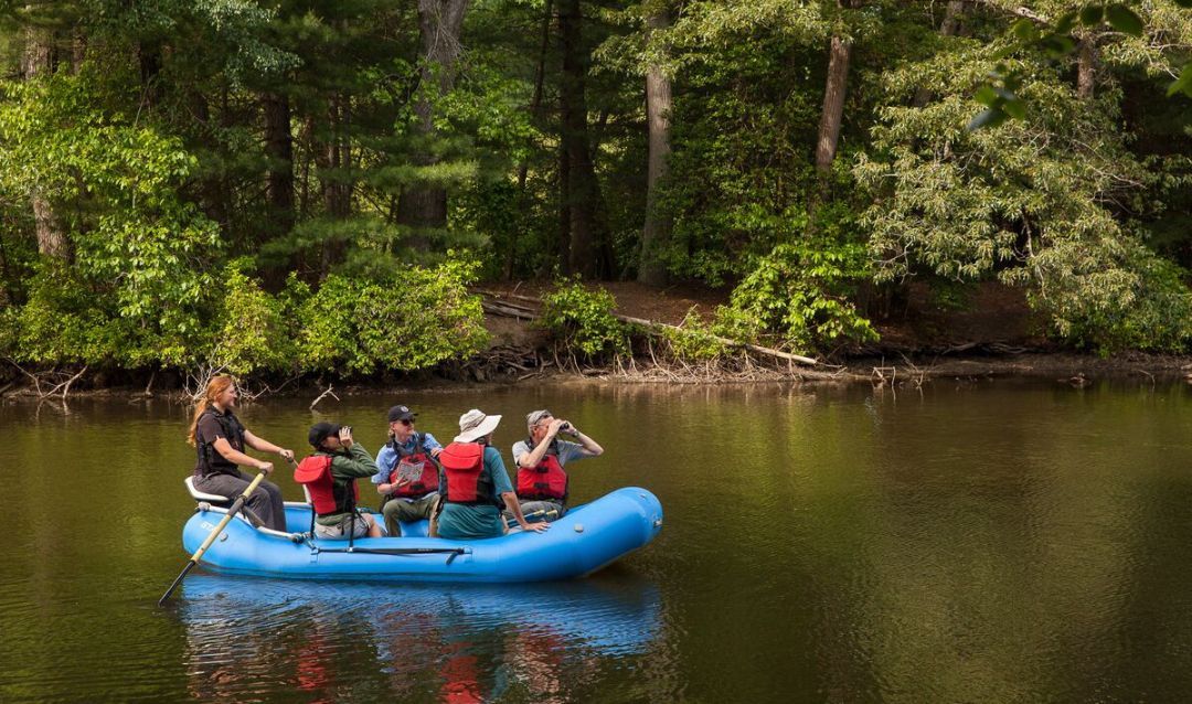 Group of people bird watching from a rafting tour at Biltmore.