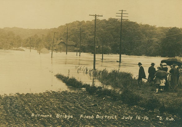 Archival image of people looking at a flooded field at Biltmore.