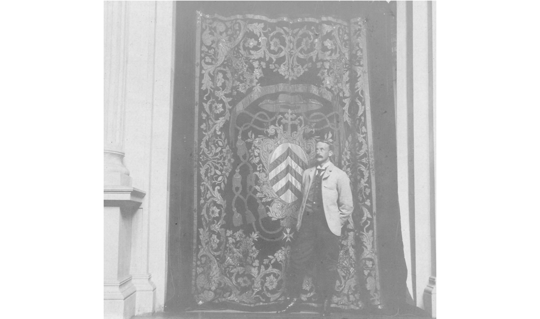 Archival photo of a man standing in front of the Cardinal Richelieu hangings