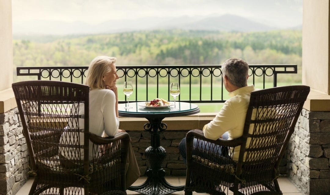 Couple sipping wine on rockers at Biltmore.