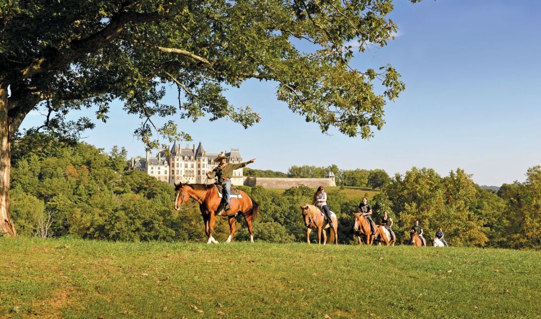 A group of people horseback Riding on Biltmore Estate.