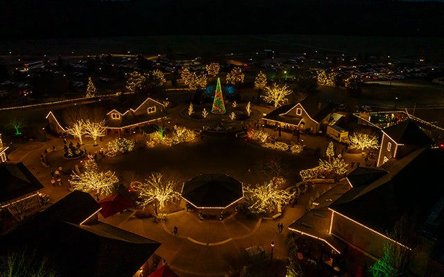 Nighttime aerial view of Antler Hill Village illuminated with Christmas lights