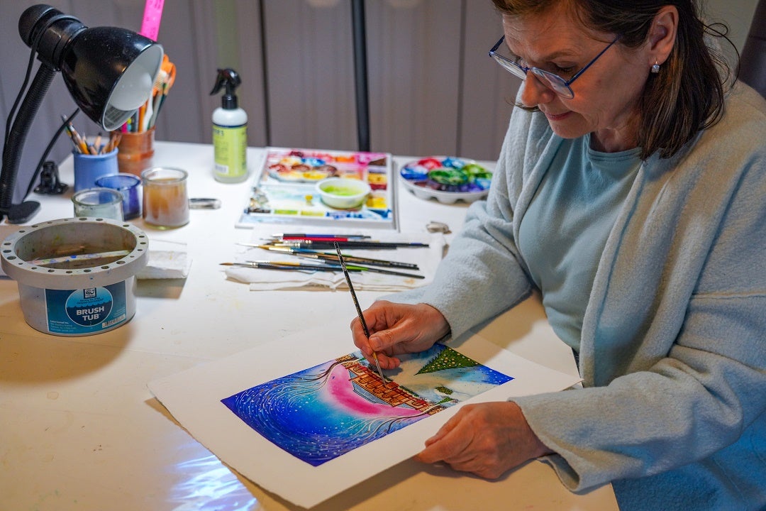 Artist working on a watercolor for the wine labels