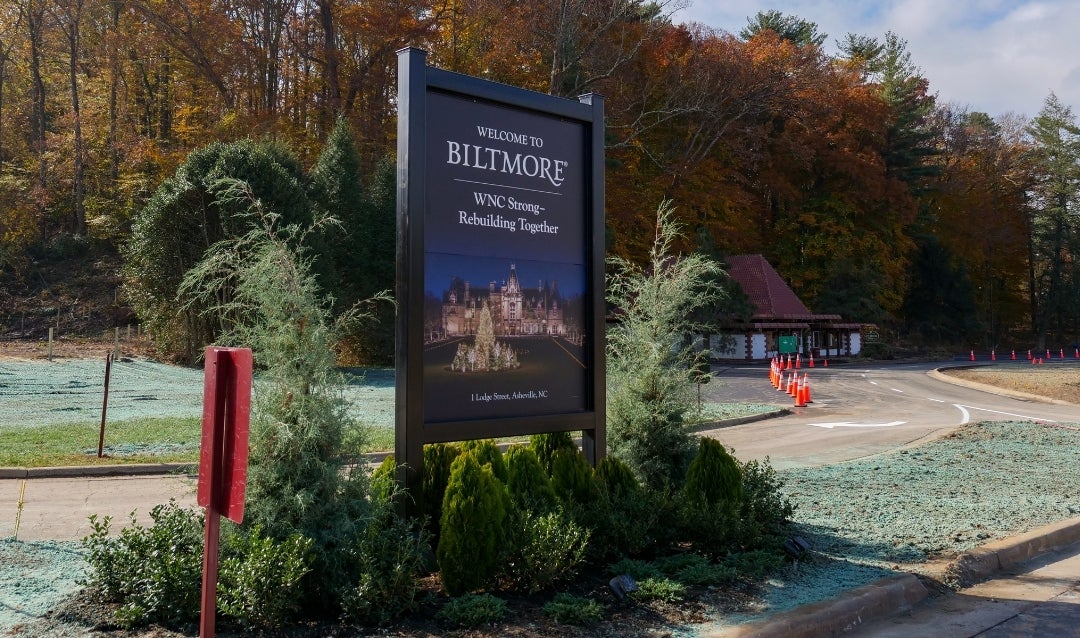 The estate's main entrance sign features a #WNCStrong message after Helene.