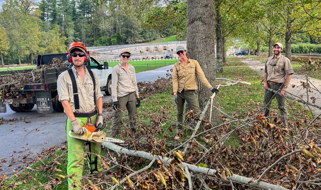 Employees clean up storm damage on the Front Lawn of Biltmore House.