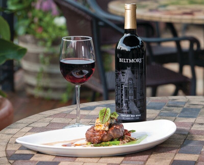 Biltmore Century Sweet Red Wine with a plate of food.