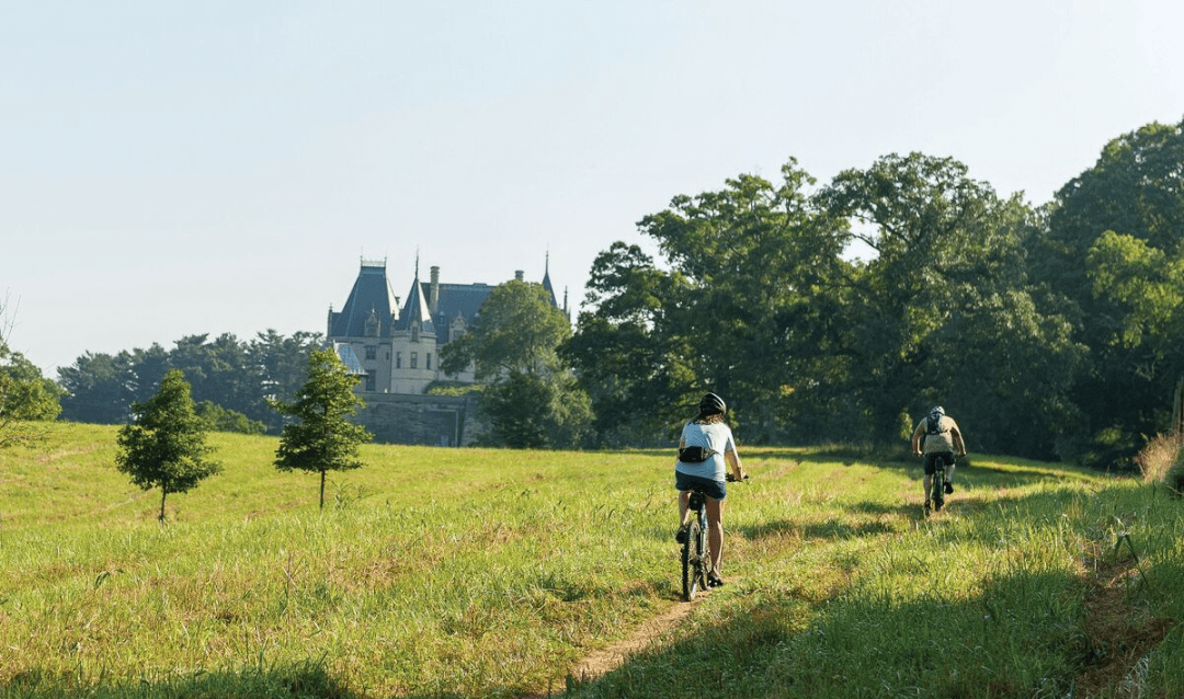 Two bike riders behind Biltmore House.