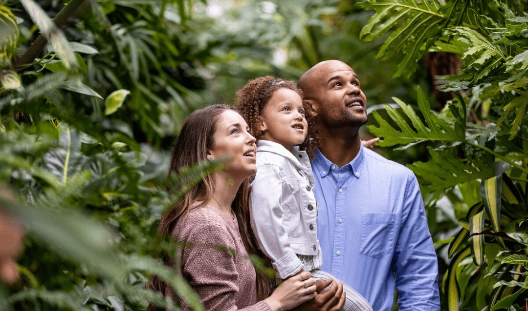 Couple with their young daughter in the Conservatory at Biltmore.