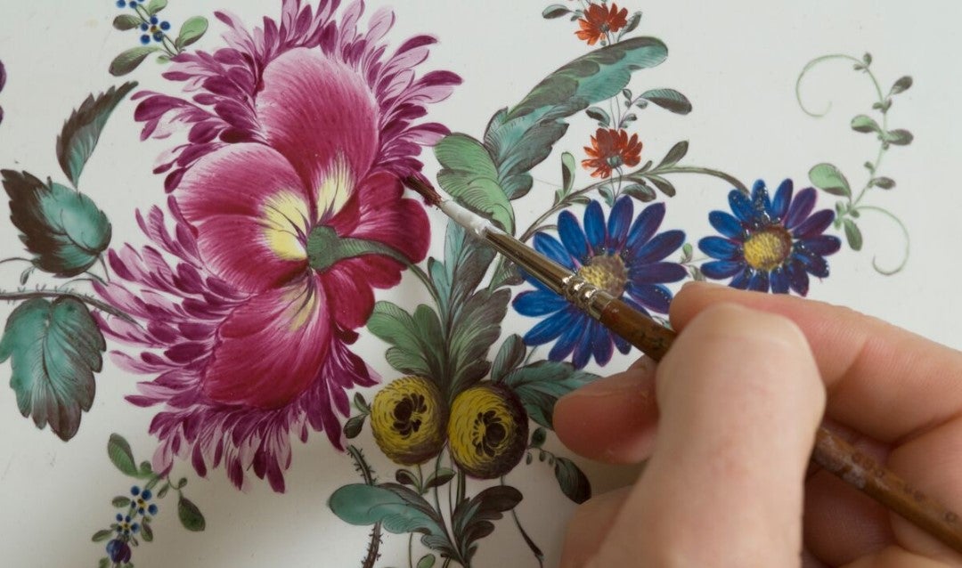 Biltmore conservator hand paints floral details in the Chimney Room.